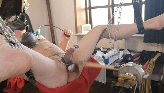 Electro stimulation and hard ball slapping by machine and wearing gas smask